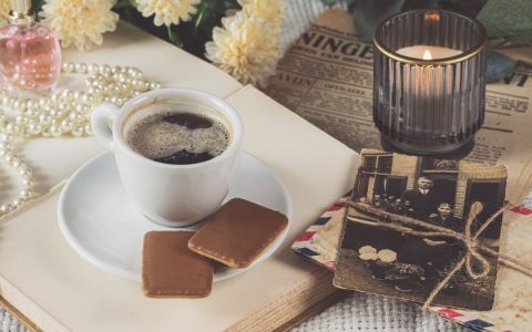 Vintage still life with coffee, cookies, and nostalgic items evoking warmth and coziness.