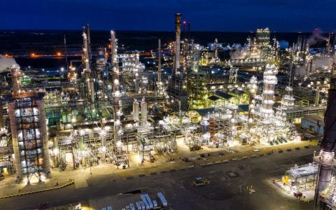 Dramatic aerial shot of an illuminated oil refinery at night in Rosemount, MN.