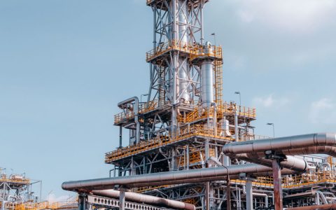 View of a large oil refinery plant with intricate pipelines in Trzebinia, Poland.