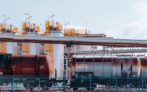 Fuel train and refinery tanks in Trzebinia, Poland, showcasing industrial energy infrastructure.