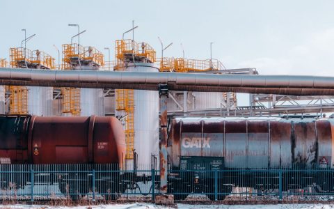 A refinery with industrial train cargo tanks in Trzebinia, Poland on a winter day.