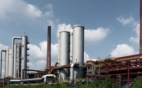 Historic industrial architecture at Zollverein Coal Mine, Essen, Germany, showcasing iconic smokestacks.