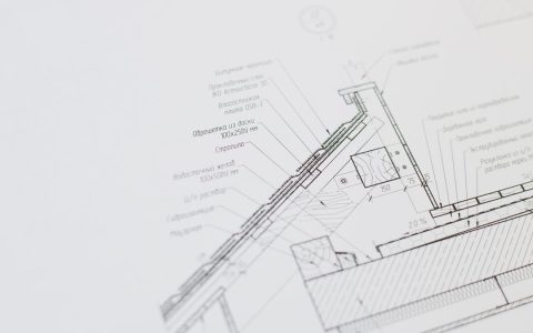 Close-up of a detailed architectural floor plan focusing on technical elements and design specifications.