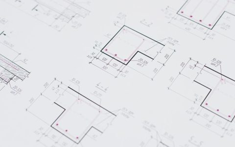 High-resolution close-up of detailed architectural blueprints showcasing precision design layouts.