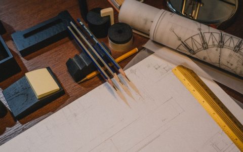 Architect's desk with blueprints and drafting tools, perfect for design and planning themes.