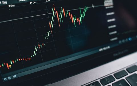 Close-up of a computer screen displaying cryptocurrency market trends and data.