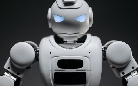 Detailed studio shot of a modern robotic toy with a dark background, showcasing technological design.