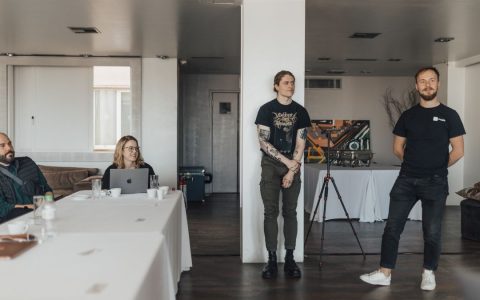 Casual team meeting with presentation in a modern office setting.