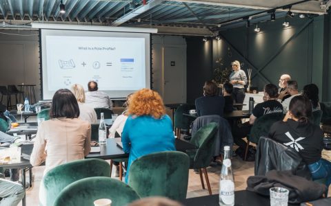 Business professionals attending a presentation in a contemporary office space.