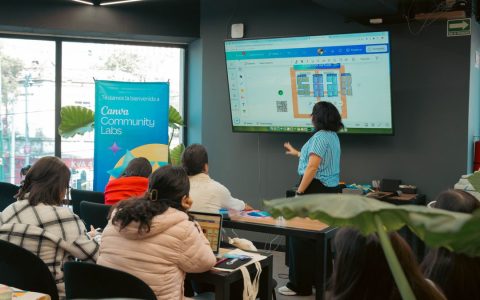 Interactive workshop session at Canva Community Labs with a presentation screen and engaged audience.