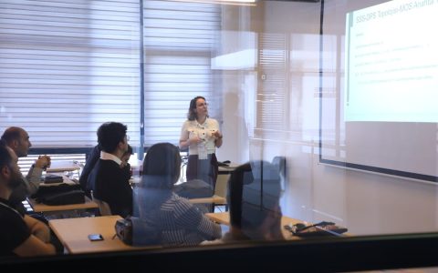 Audience attending a business presentation in a modern office environment.