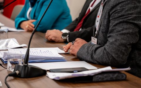 Close-up of professionals discussing documents at a business meeting in Ankara, Turkey.