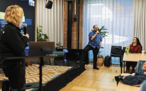 Engaging business presentation with audience interaction in a modern office environment.