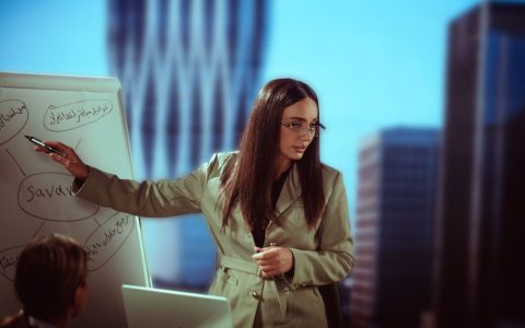 Businesswoman giving a presentation in modern office setting, Baghdad.