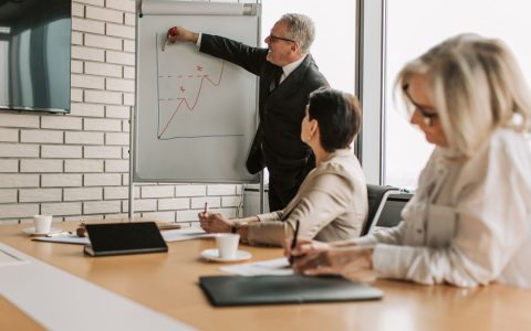 A group of professionals engaging in a business presentation in a stylish office setting.