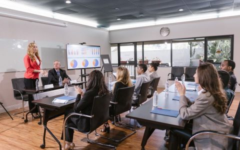 Business professionals attending a meeting in a modern conference room.