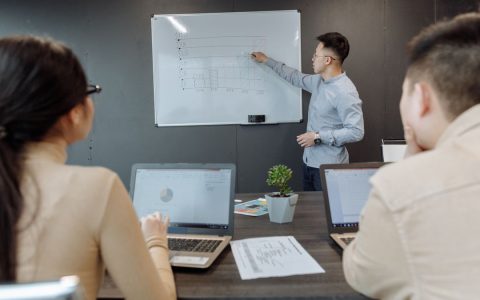 Business team discussing project strategy during a meeting in a modern office.