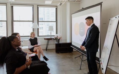 Professional business meeting with diverse team in a modern office setting.